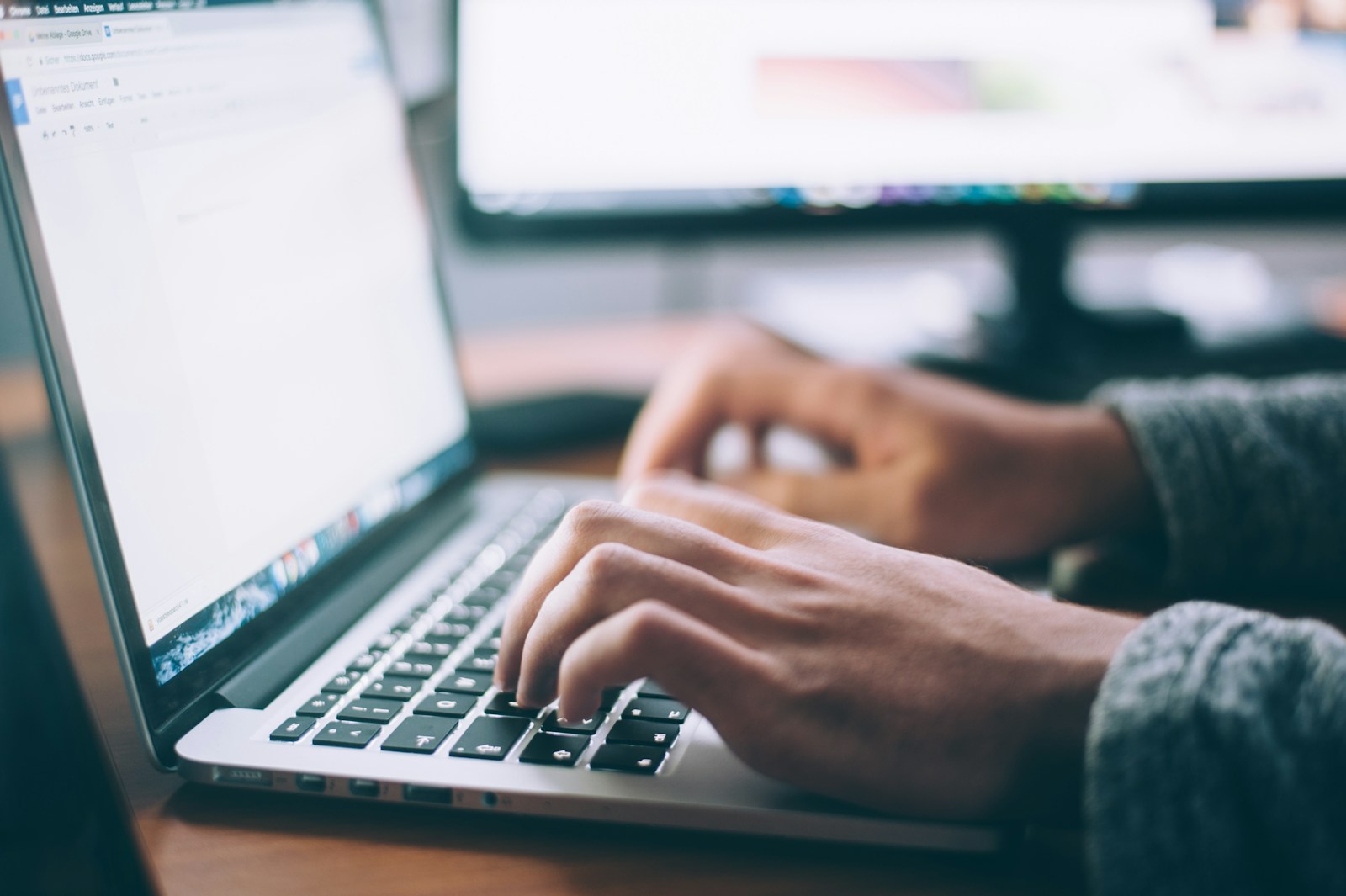 Participant working through an AI spreadsheet exercise on a laptop